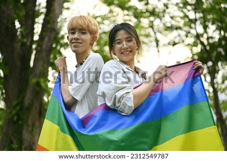 Celebration Pride month of LGBT concept with LGBT youth holding a rainbow flags.