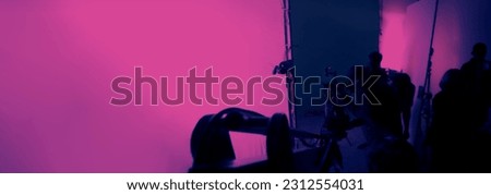 Blurry images of film crew working and filming in video production studio which using equipments such as cinema camera big film light and soft box or light diffusion panel. TV Commercial Film industry
