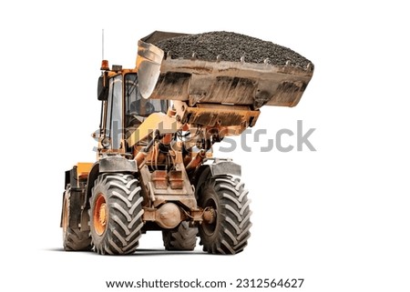 Powerful wheel loader or bulldozer isolated on white background. The loader transports crushed stone or gravel in a large bucket. Powerful modern technology. Rental of construction equipment Royalty-Free Stock Photo #2312564627