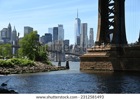 View of Manhattan skyline with Brooklyn Bridge across the East River from Brooklyn's DUMBO neighborhood.