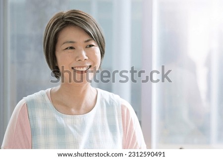 Images of Japanese middle-aged female childcare workers, housekeepers, housewives, etc. that could be used for mid-career or career change. Royalty-Free Stock Photo #2312590491