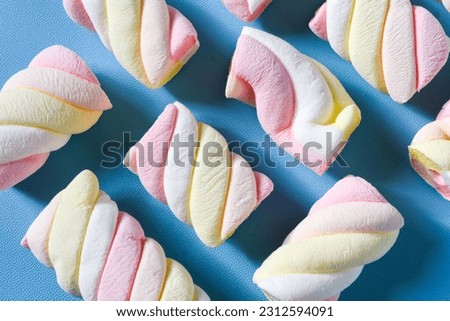 Background with marshmallow on a blue background.