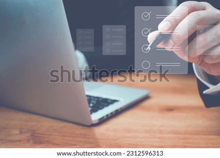 Business performance checklist, Quick checklist and clipboard management concept, job applicants, businessman using laptop doing online checklist survey,Employees must complete the online survey form. Royalty-Free Stock Photo #2312596313