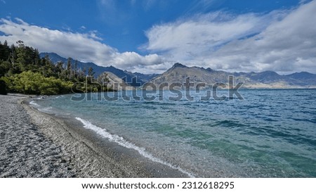 Beach at Lake Wakatipu along the Glenorchy Queenstown Road. The beach is called Sunshine Bay. The place can be reached via Sunshine Bay track