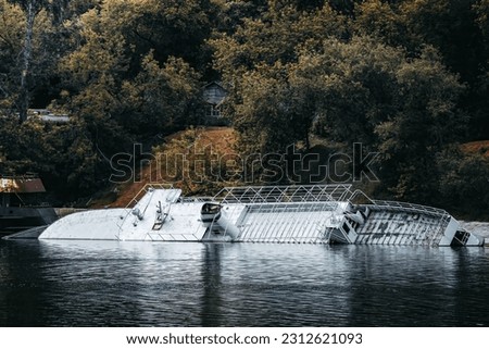 Sunked ship in a river. abandoned wrecked ship, riverside landscape Royalty-Free Stock Photo #2312621093