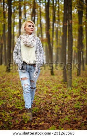 Blonde mature caucasian woman outdoor in the forest