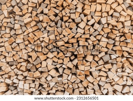 Firewood stack background of woodpile pattern cut from tree wood log with natural texture for fireplace fagot in winter 