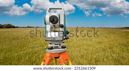 Cartography. Theodolite on the background of a topographic map. Geodesic and cartographic equipment. Study of the area. Mapping. Work of the cartographer. Topography and cartography. Royalty-Free Stock Photo #2312661509