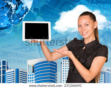 Beautiful businesswoman smiling and holding hand tablet with blank screen. Other hand points to tablet. Buildings, money and Earth as backdrop. Elements of this image furnished by NASA