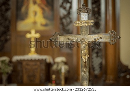 Church cross made of silver with Jesus Christ. Altar church with crosses. Soft selective focus. Artificially created grain for the picture