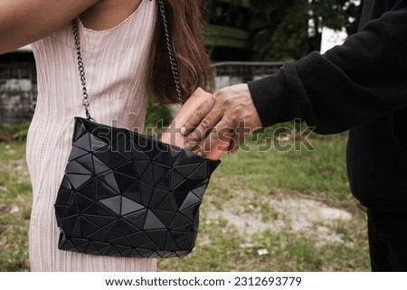 Man robbed woman, Thief stealing in public Royalty-Free Stock Photo #2312693779