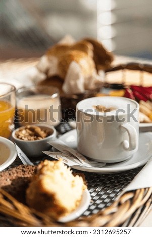 tray of breakfast in bed at a hotel room service vertical Royalty-Free Stock Photo #2312695257