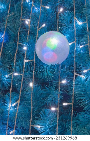 Ornamental electric light ball hanging on Cristmas tree