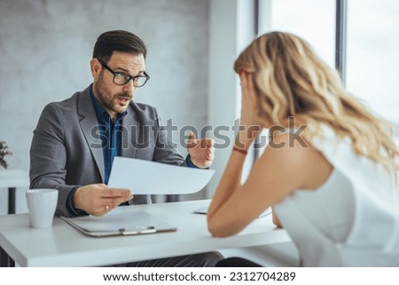 Mad male worker yelling at female colleague asking her to leave office, multiracial coworkers disputing during business negotiations, employees cannot reach agreement, blaming for mistake or crisis Royalty-Free Stock Photo #2312704289