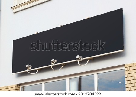 Large black billboard banner on a storefront mockup. Blank white restaurant or shop sign mock up template.