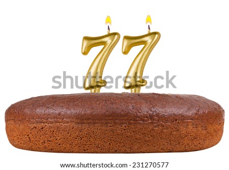 birthday cake with candles number 77 isolated on white background