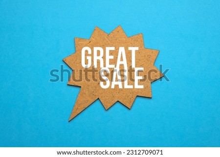 Great sale words on wooden sheech bubble on blue paper background. Big sale concept. Copy space. Royalty-Free Stock Photo #2312709071