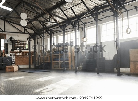 Fitness, empty gym and equipment for exercise, workout and sports for wellness, weightlifting and studio. Health club, interior and recreation center for bodybuilding, training and room for practice Royalty-Free Stock Photo #2312711269