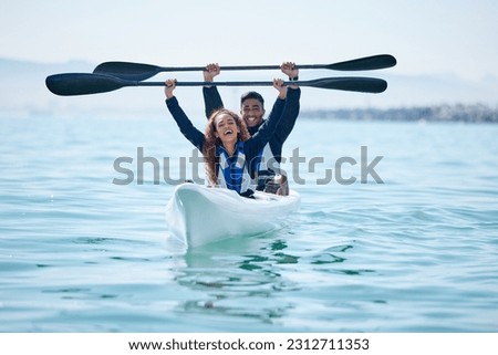 Kayak, sports and team celebrate win on rowing boat on a lake, ocean or river for fitness challenge. Man and woman or winning couple with a paddle for adventure, teamwork exercise or travel on water Royalty-Free Stock Photo #2312711353