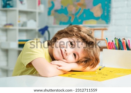 Portrait of elementary pupil looking at camera. Schoolkid or preschooler learn. Portrait of pupil of primary school study indoors. School dream. Daydreamer school child. Dreamy school kid face. Royalty-Free Stock Photo #2312711559