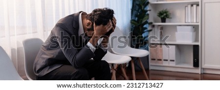 Nervous and panic job applicant with stressful emotion on job interview while he sitting and waiting for his turn. Sad businessman holding his head with hands after making mistake. Trailblazing Royalty-Free Stock Photo #2312713427