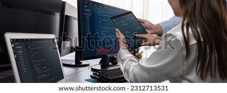 Software development team working together in office, coding script display on computer monitor. Programmer and software engineer working in tech developer company. Trailblazing Royalty-Free Stock Photo #2312713531