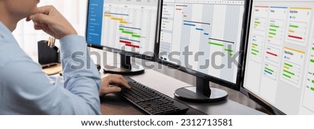 Project manager planning schedules for business task on office using gantt chart software display on screen. Modern business management and work flow organization. Trailblazing Royalty-Free Stock Photo #2312713581