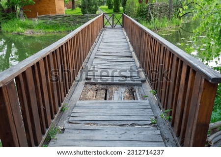 A broken wooden bridge is unsuitable for crossing the river Royalty-Free Stock Photo #2312714237