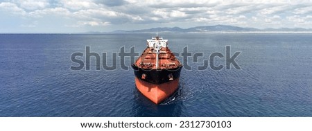Aerial drone ultra wide panoramic photo with copy space of huge bulk carrier tanker anchored in deep blue Aegean sea