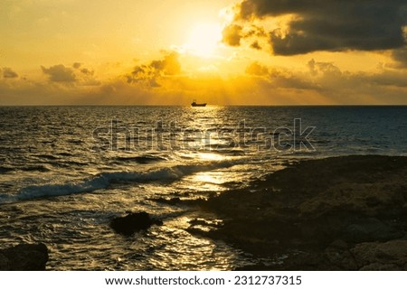 Beautiful sunset sky at beach in Paphos Cyprus showing Demetrios shipwreck and Venus beach 04 June 2023