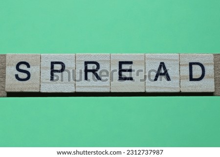 word spread made of small gray wooden letters on a green paper background