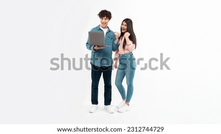 Digital Victory. Joyful Young Couple With Laptop Shaking Fists Celebrating Great Online News Browsing Internet Together Standing Over White Studio Background. E-Learning Success. Panorama Royalty-Free Stock Photo #2312744729