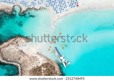 Cyprus -Nissi Beach in Ayia Napa, clean aerial photo of famous tourist beach in Cyprus, the place is a known destination on island and is formed from a smaller island just near the main shore Royalty-Free Stock Photo #2312748495