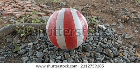 red and white ball, made of plastic, suitable for sports.