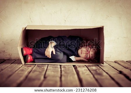 Portrait of young businessman in cardboard box. Think outside the box. Copy space for your text
