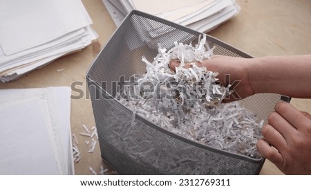 Shredded private confidential documents. Shredded paper in a shredder container Royalty-Free Stock Photo #2312769311