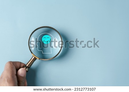 Magnifier focus to human brain and smile mental health sign positive thinking, idea creative intelligence thinking or Awareness with energy boost, energy or fresh wellness emotion concept. Royalty-Free Stock Photo #2312773107