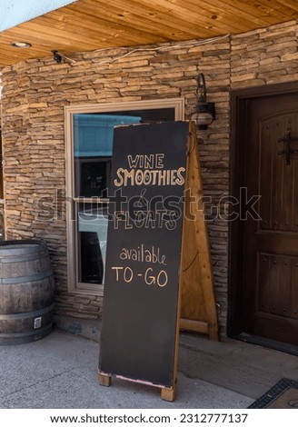 A wooden sign outside of a bar restaurant for alcoholic drinks on North Fraley Street in Kane, Pennsylvania, USA on a sunny spring day