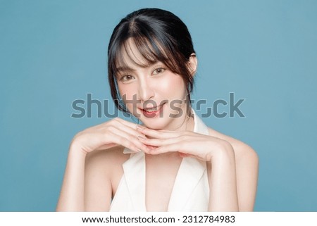 Young Asian beauty woman bangs hair with makeup lovely style on face and perfect clean skin care on isolated blue background. Facial treatment, Cosmetology, plastic surgery. Royalty-Free Stock Photo #2312784983