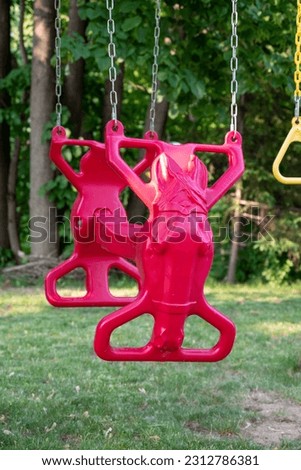 A swing with a seat shaped like a horse's head