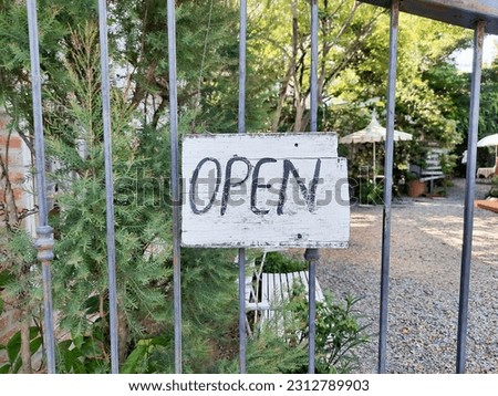 wooden sign indicating that the store is open.