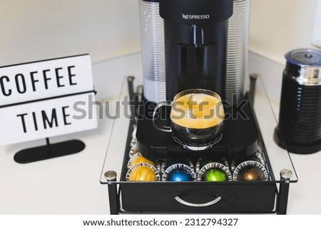 Coffee machine in white kitchen.