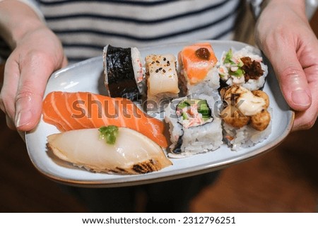 home made Japanese sushi and nigiri in one plate which mix variety of sushi. 
