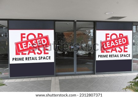 Two retail for lease signs with a leased sticker over it