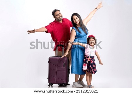 Indian family with luggage on white background.