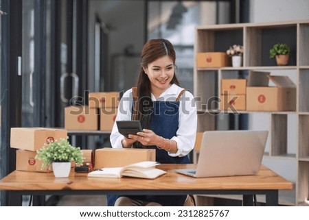 Portrait business woman smile and use tablet checking information on parcel shipping box before send to customer. Entrepreneur small business working at home. SME business online marketing.