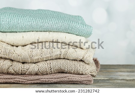 Knitting clothes on light background