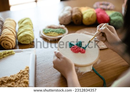 Young female Embroidery with punch needle on canvas, Handicraft at workshop.
 Royalty-Free Stock Photo #2312834357