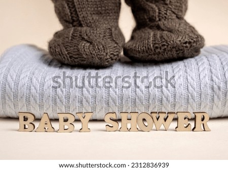 baby boy clothes on rope,blue blanket bow and bodysuit,dry cotton.word baby from wooden letters,baby shower or its a girl.toddler infant booties knitted pattern.eco blocks.ultrasound picture of fetus.