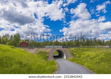 Beautiful panoramic landscape view of tunnel road on blue sky background. Sweden.